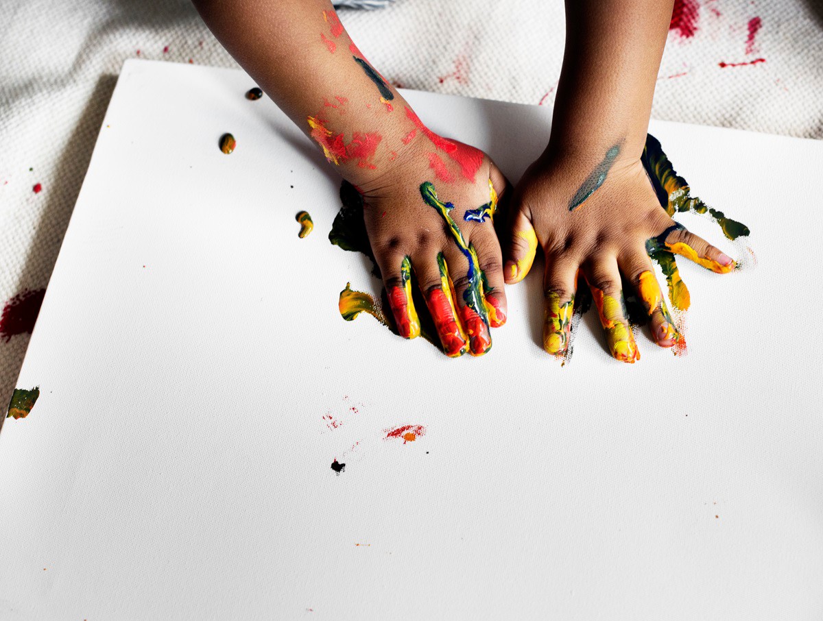 Black kid enjoying his painting