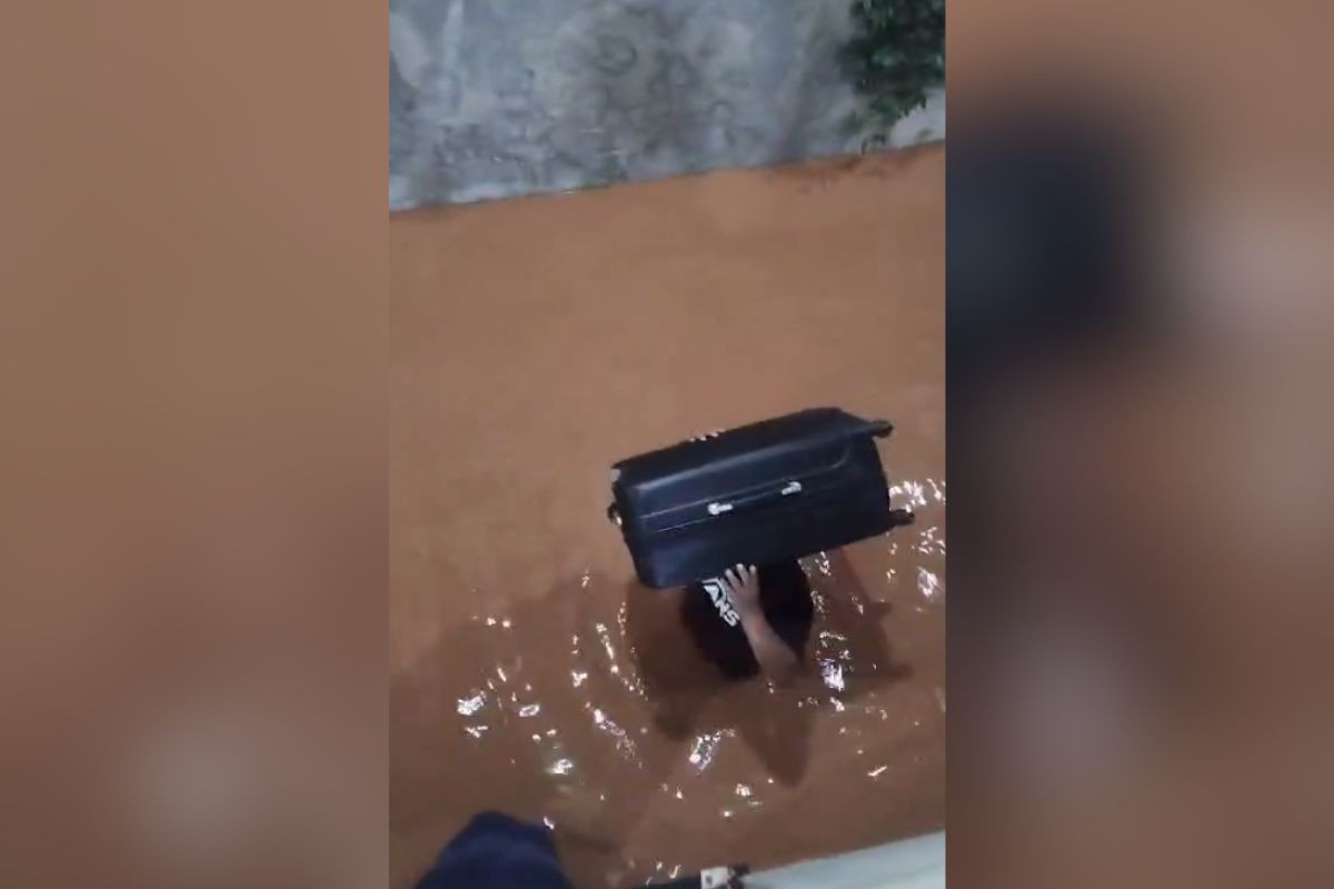Morador de Santana do Paraíso tenta salvar pertences após água invadir casa