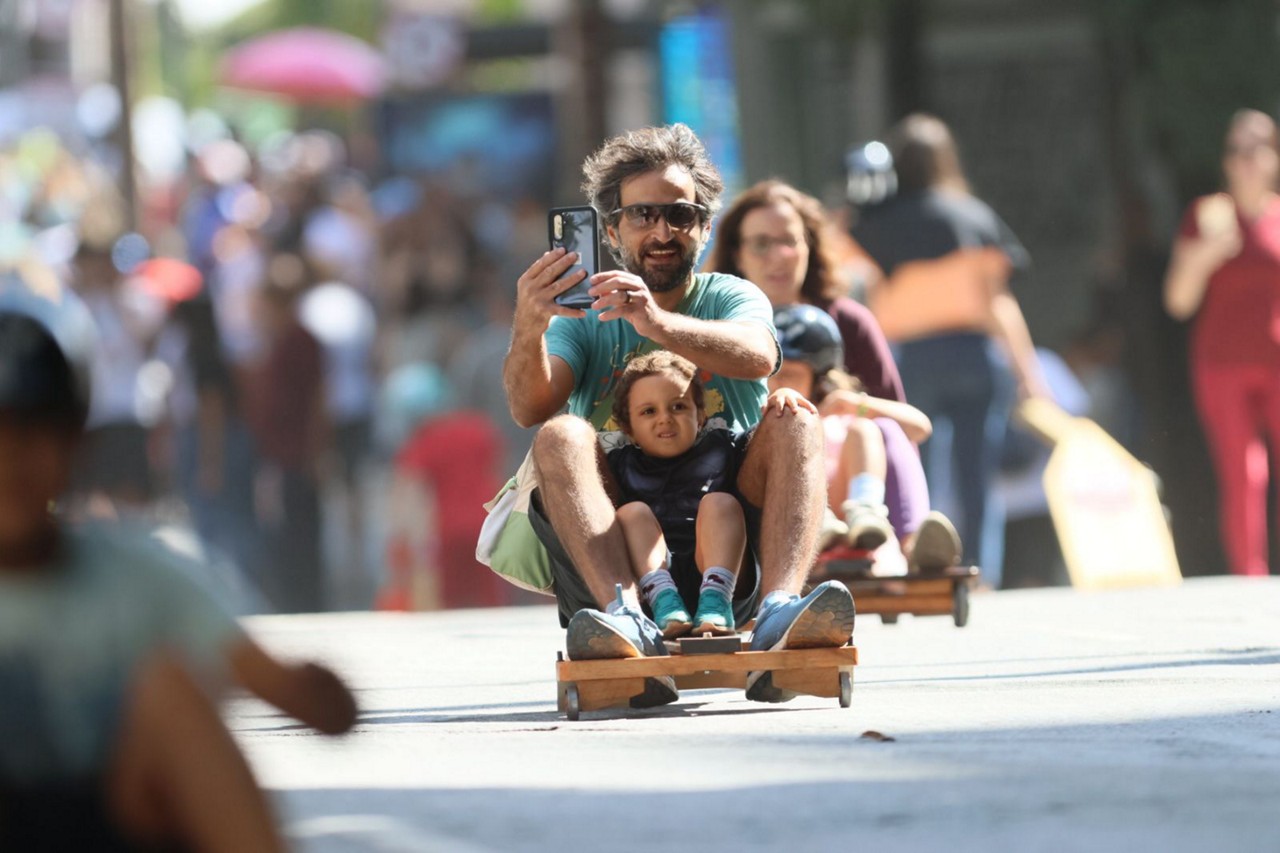 Cartazes com informações sobre os efeitos do uso excessivo de telas digitais por crianças foram espalhados ao longo do trajeto da corrida