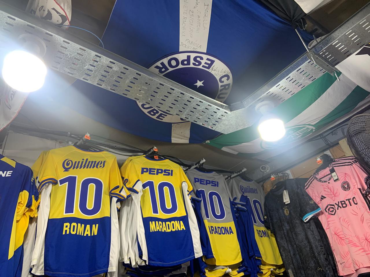 Artigos de Cruzeiro e Atlético expostos em loja em frente à Bombonera