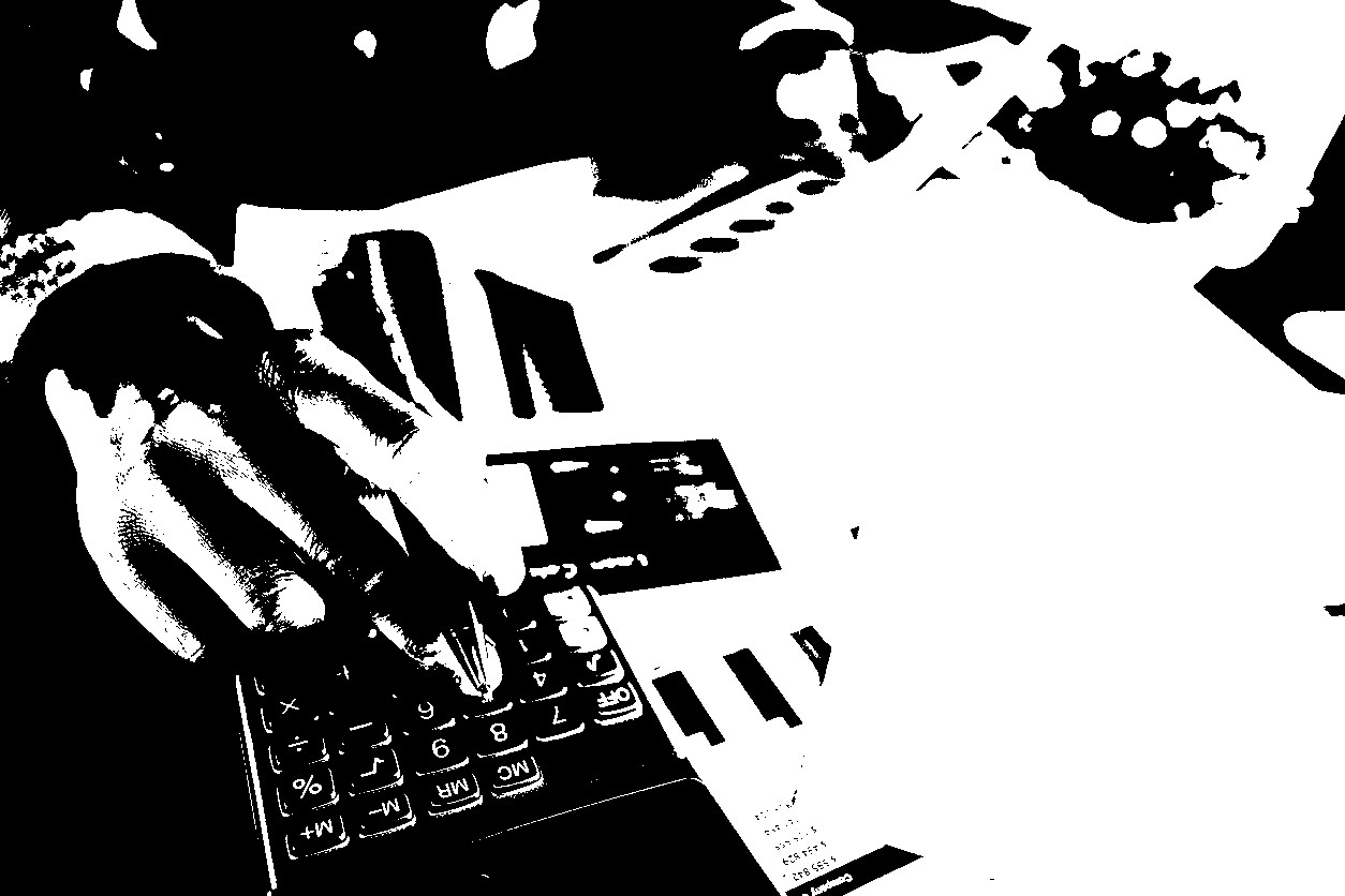 Close up businessman using calculator and reading paper document about business data, accountancy document, graph profit company.