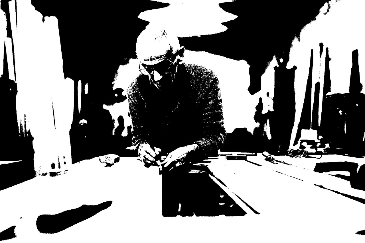 Close up shot of old master carpenter working in his woodwork or workshop