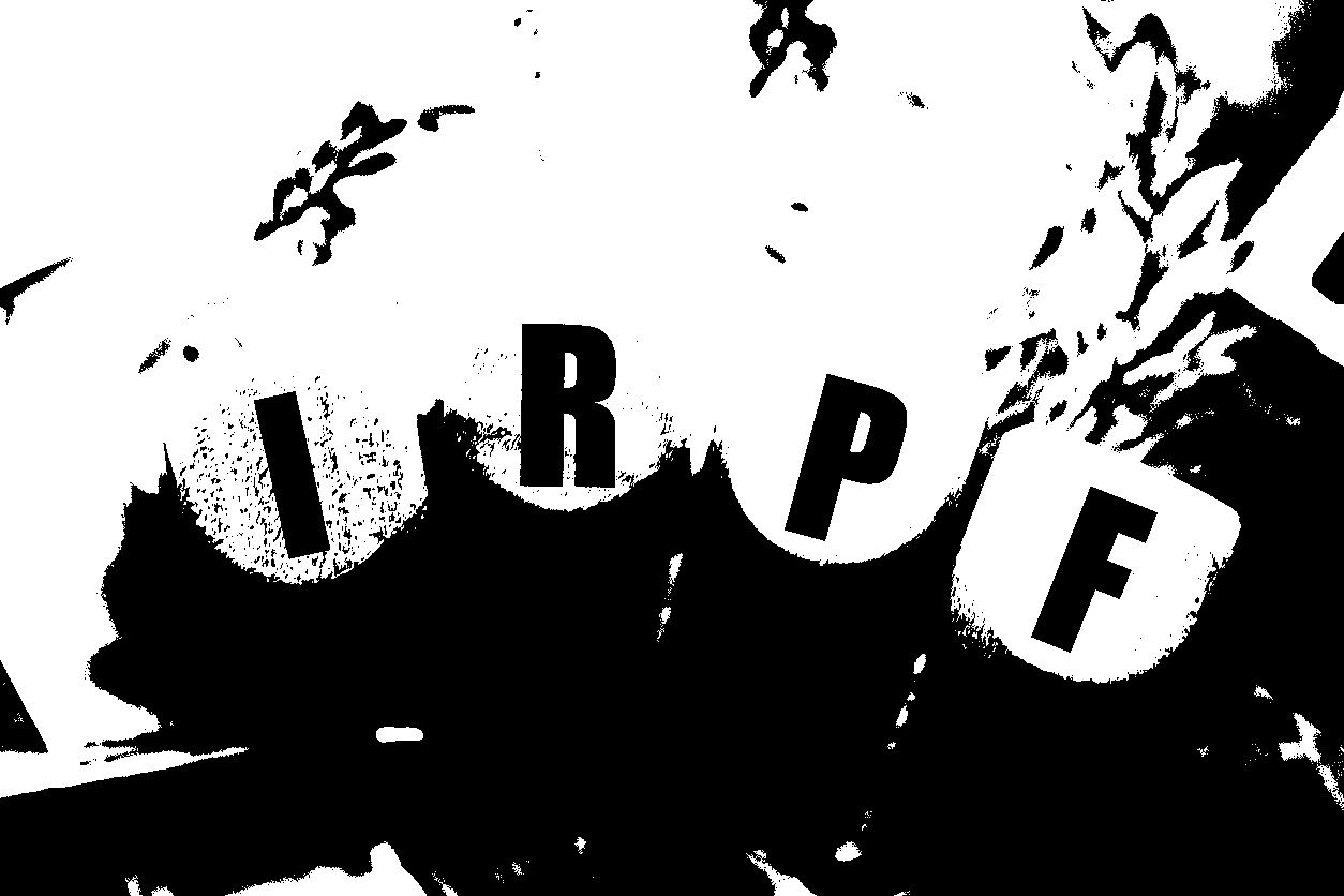 The acronym IRPF for Personal Income Tax in Brazilian Portuguese written on wooden dice. Notes of the Brazilian Real in the composition.
