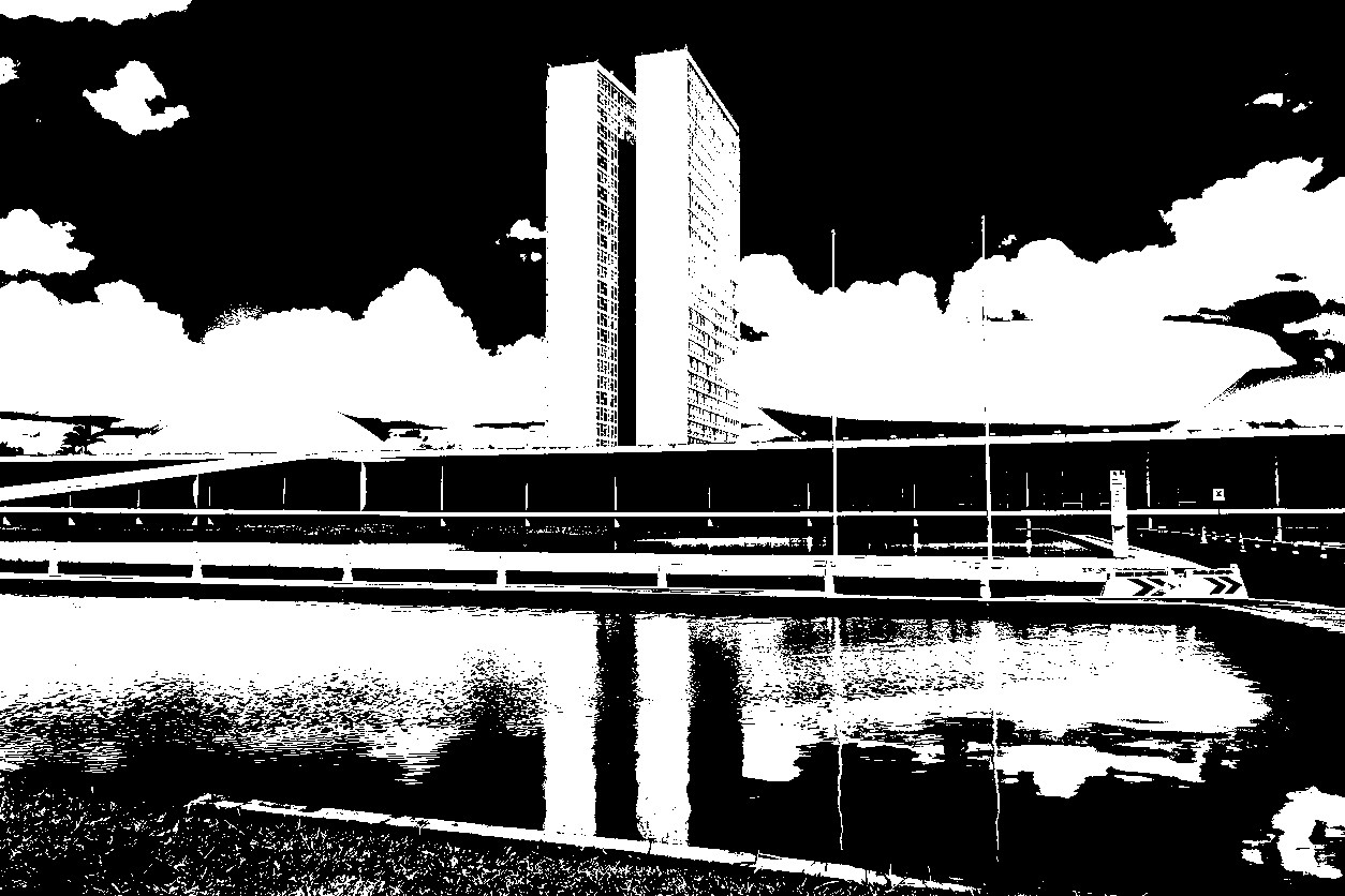 Brasilia, Federal District, Brazil – December 25, 2021: National Congress Palace with reflection in the water mirror, on a clear day with cloudy sky. The National Congress Palace is a work of architect Oscar Niemeyer.