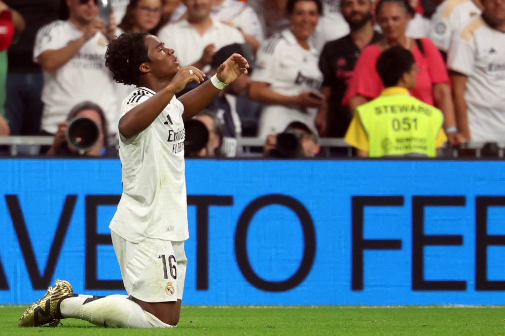 Real Madrid's Brazilian forward #16 Endrick celebrates scoring his team's third goal during the Spanish league football match between Real Madrid CF and Real Valladolid FC at the Santiago Bernabeu stadium in Madrid on August 25, 2024. (Photo by Pierre-Philippe MARCOU / AFP)