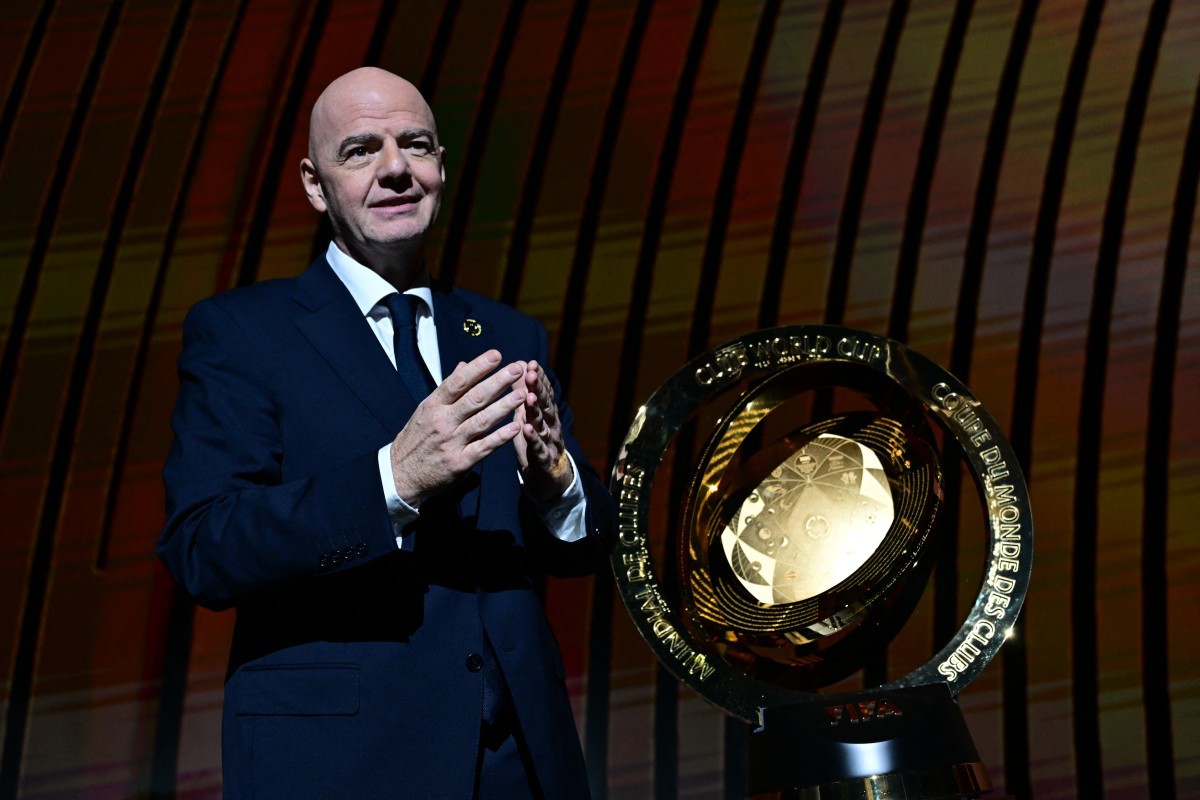 President of FIFA Gianni Infantino speaks next to the trophy during the 2025 FIFA Club World Cup Draw ceremony in Miami on December 5, 2024. (Photo by Giorgio VIERA / AFP)