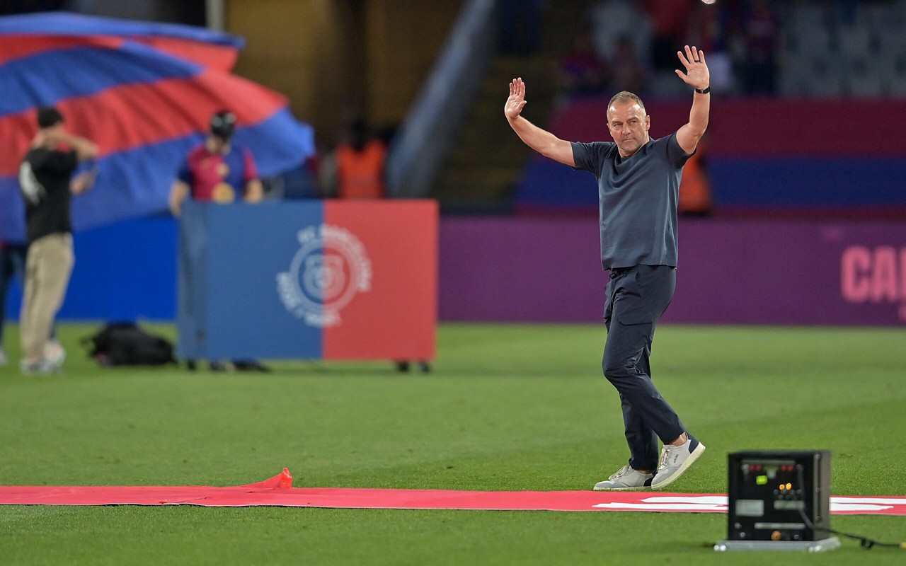 Barcelona's German coach Hans-Dieter Flick waves as he celebrates their 28th Liga title after the Spanish league football match between FC Barcelona and Villarreal CF at Estadi Olimpic Lluis Companys in Barcelona on May 18, 2025. (Photo by MANAURE QUINTERO / AFP)