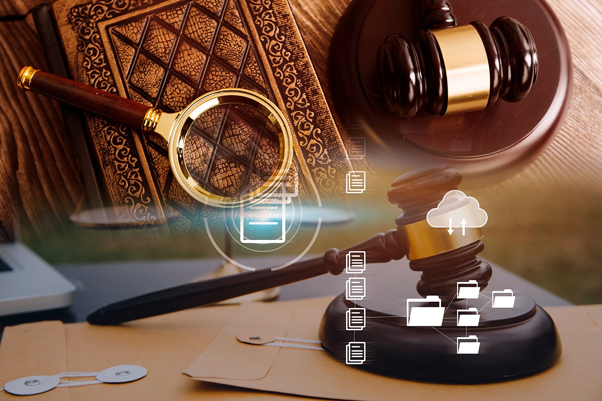 Justice and law concept.Male judge in a courtroom with the gavel, working with, computer and docking keyboard, eyeglasses, on table in morning light