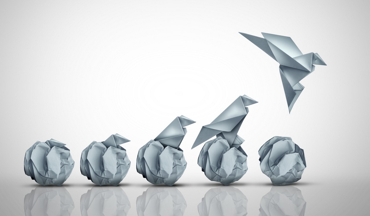 Emerging Potential And Success as an unstoppable origami bird born rising from an egg representing business start up or development breakthrough and ambition to conquer opportunities.