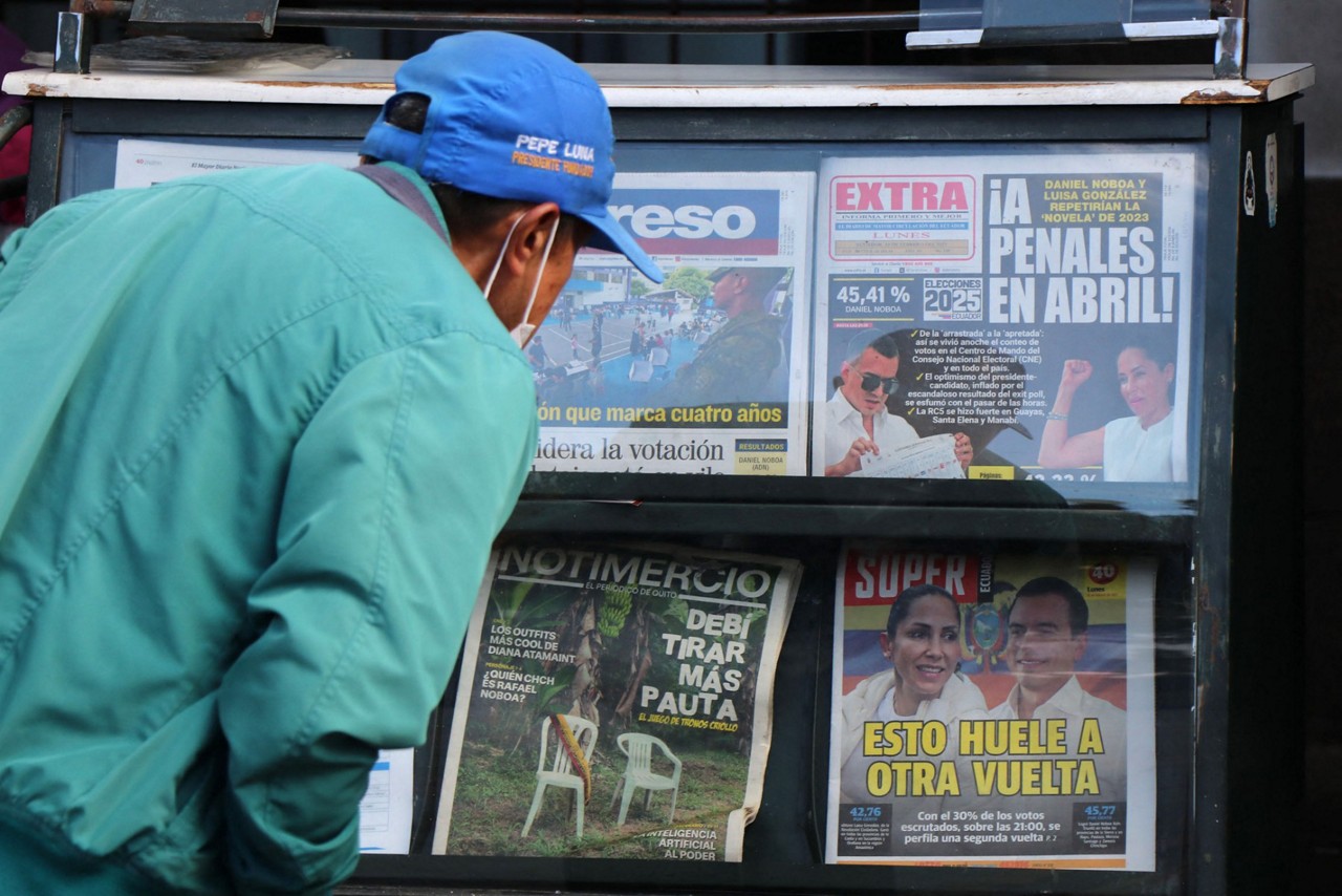 Equatoriano lê as notícias do resultado do primeiro turno das eleições presidenciais (Photo Galo Paguay/AFP)