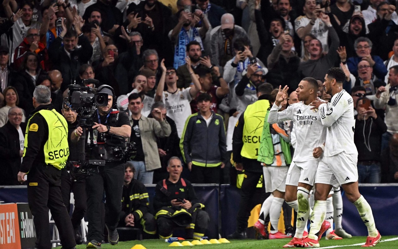 Kylian Mbappe e Jude Bellingham celebram terceiro gol do Real Madrid sobre o Manchester City (Foto: JAVIER SORIANO / AFP)