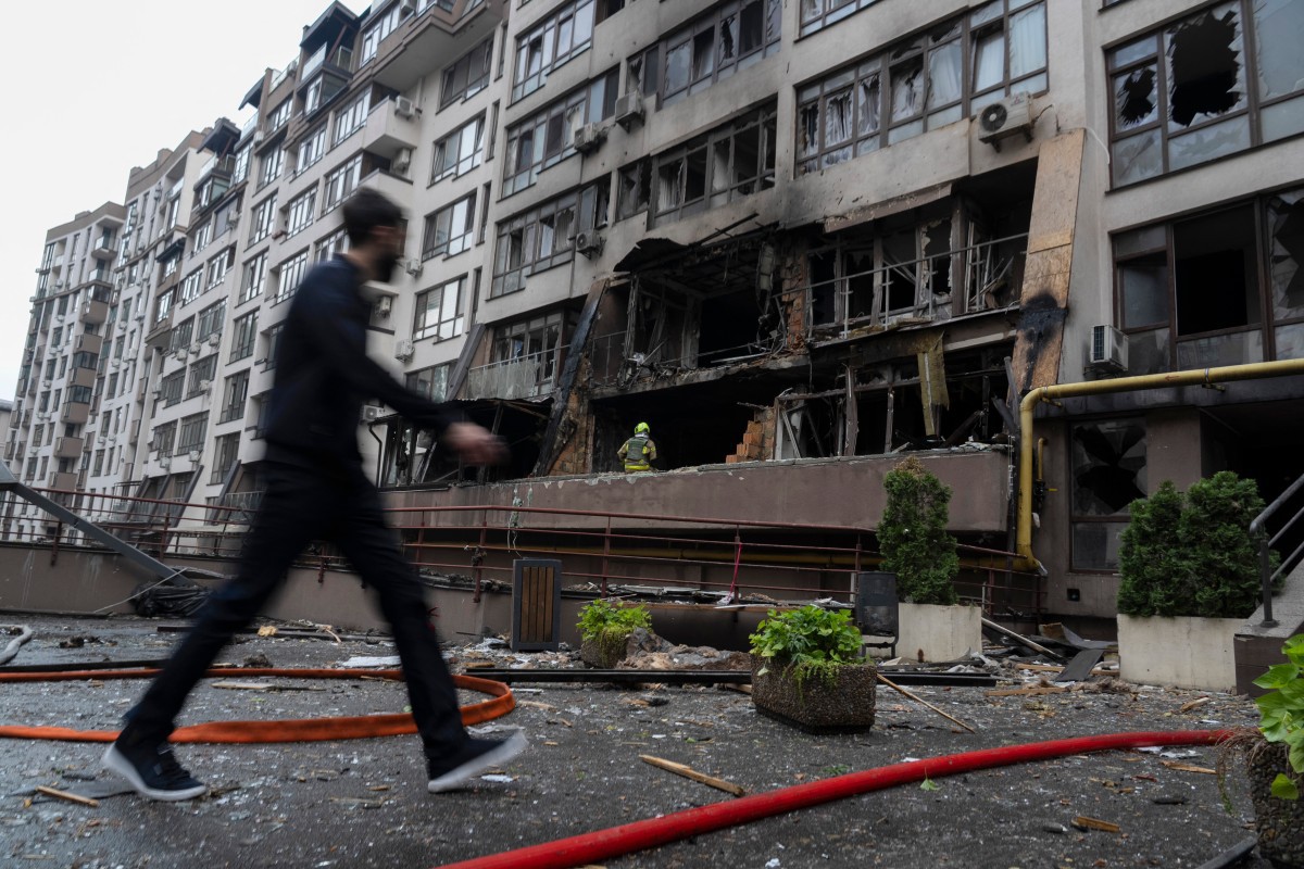 Um homem passa por um prédio residencial danificado após um ataque russo em Kiev, nesta segunda-feira