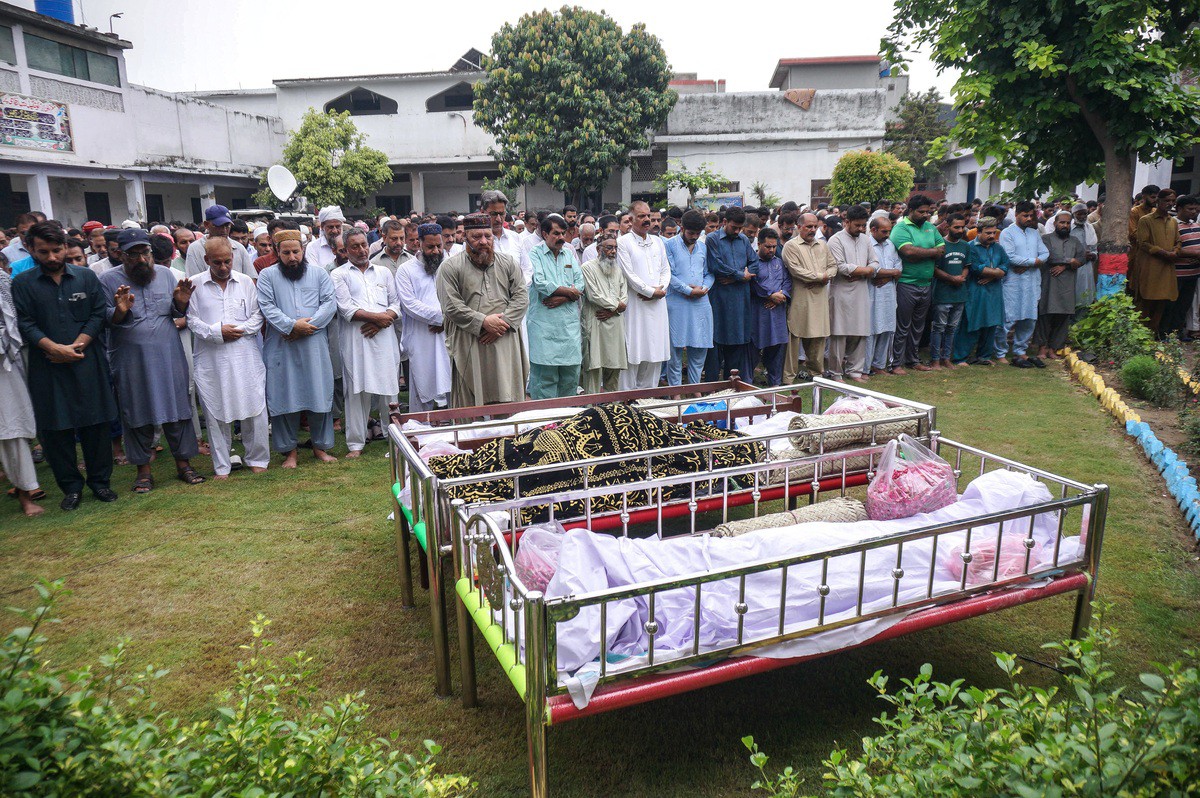 Residents and relatives offer funeral prayers for the victims who died in flash floods in Sialkot, in Punjab province, on June 28, 2025. Flash flooding in Pakistan's mountainous northwest has killed 11 people, including several children, at the start of the monsoon season, disaster management officials said. (Photo by Aftab RIZVI / AFP)
