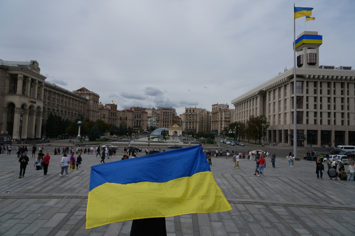 Uma pessoa segura uma bandeira ucraniana na Praça da Independência em Kiev no Dia da Independência da Ucrânia