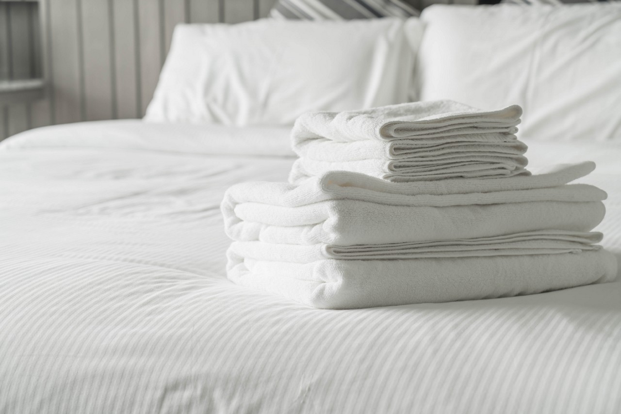 White towel on bed decoration in bedroom interior - Vintage light Filter