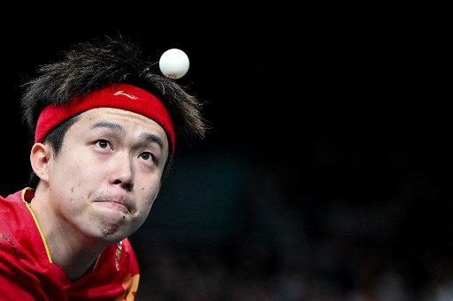 China's Wang Chuqin eyes the ball as he plays a return to Sweden's Truls Moregard during their men's table tennis singles round of 32 at the Paris 2024 Olympic Games at the South Paris Arena in Paris on July 31, 2024. (Photo by JUNG Yeon-je / AFP)
