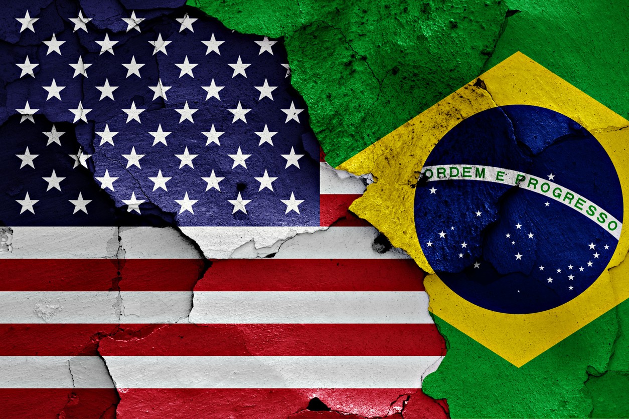 flags of United States and Brazil painted on cracked wall