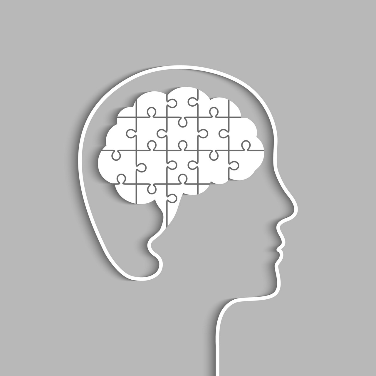 Head and brain made of jigsaw puzzle pieces. Complete and whole human mind concept. Papercut art, vector illustration.