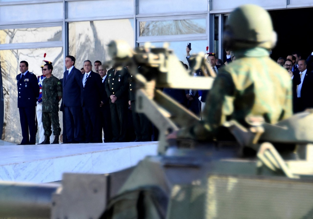 O então presidente Jair Bolsonaro, juntamente com comandantes das Forças Armadas e ministros, participam de um desfile de veículos militares em frente ao Palácio do Planalto, em 10 de agosto de 2021