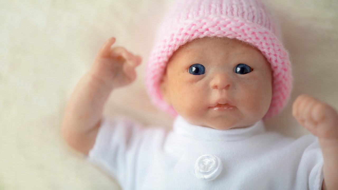 premature reborn doll close up  beautiful blue eyes , selective focus , horizontal image shot  for copy space  and text