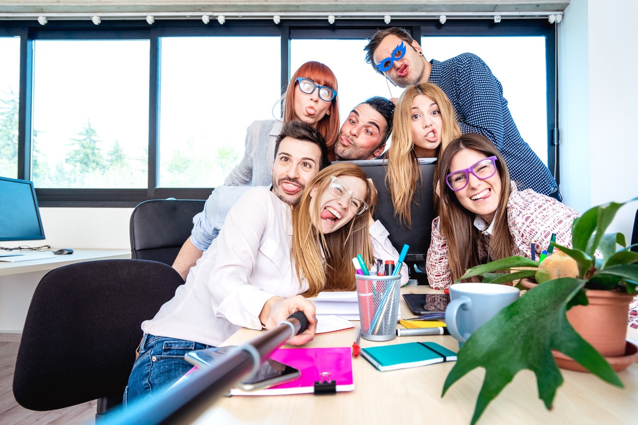 Young people employee workers taking happy selfie with stick - Life style concept of human resource on working fun time - Startupper at college office - Bright azure filter