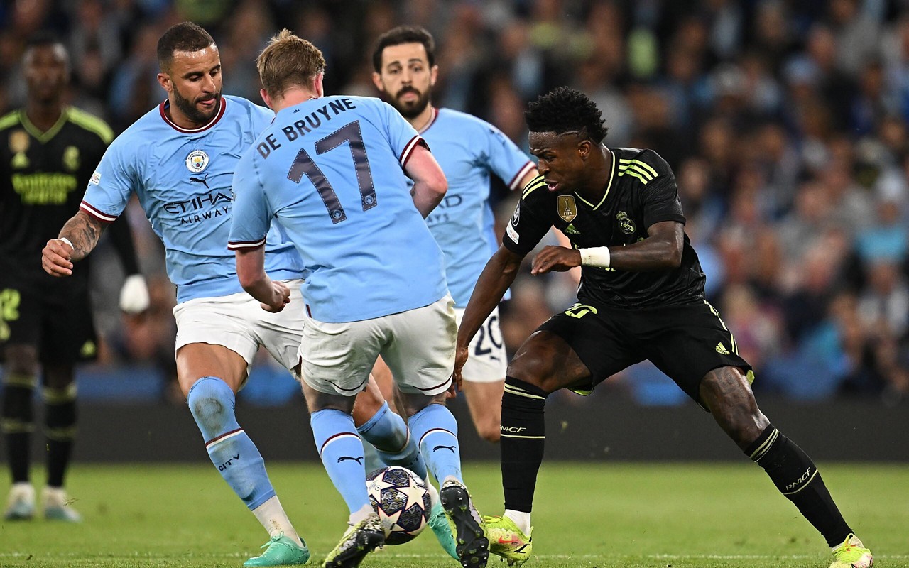 Manchester City e Real Madrid em ação na Champions League (Foto: Paul Ellis/AFP)
