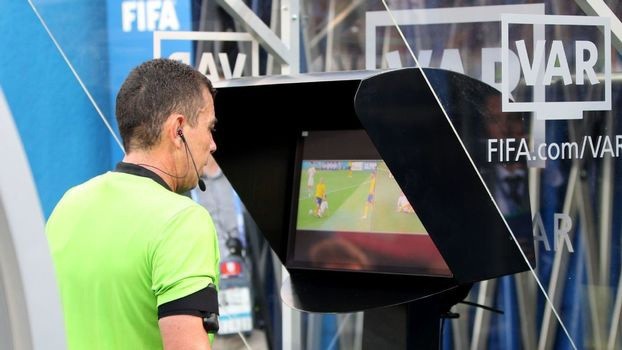 Árbitro confere imagens de lance durante partida de futebol