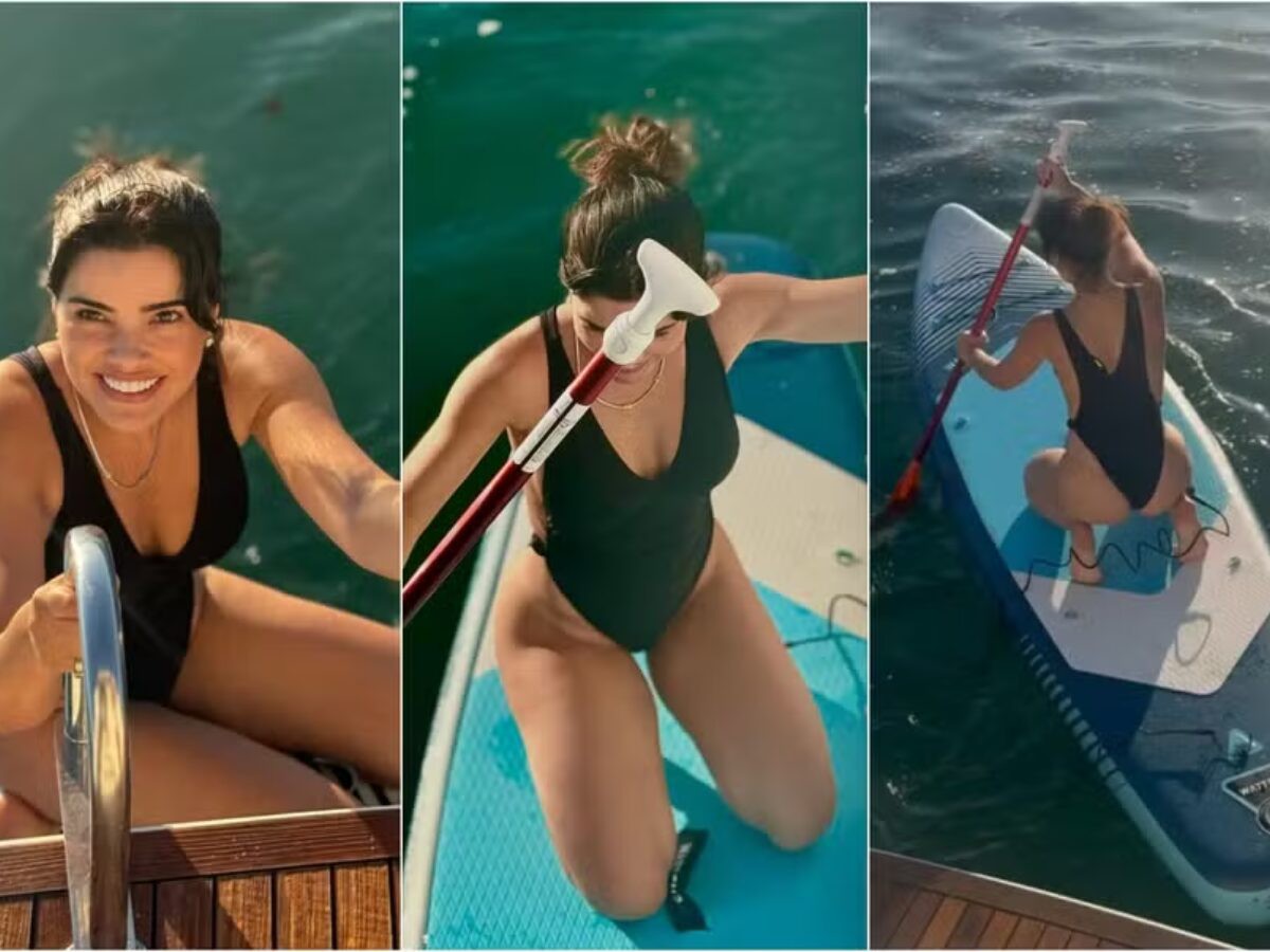 De maiô, Vanessa Giácomo se arrisca no stand up paddle durante passeio de lancha com os filhos