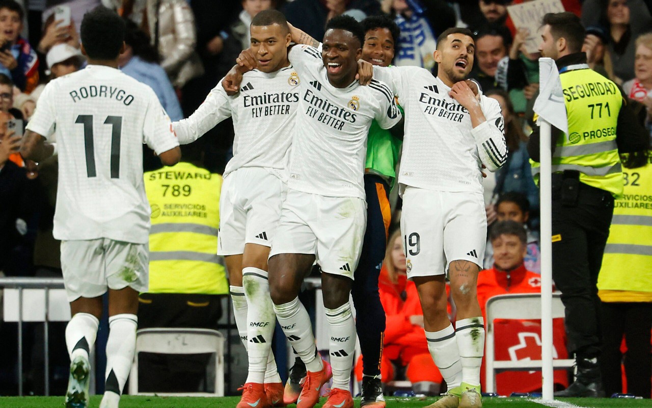 Vini Jr e seus companheiros comemorando o segundo gol do Real Madrid (Foto: PIERRE-PHILIPPE MARCOU/AFP)